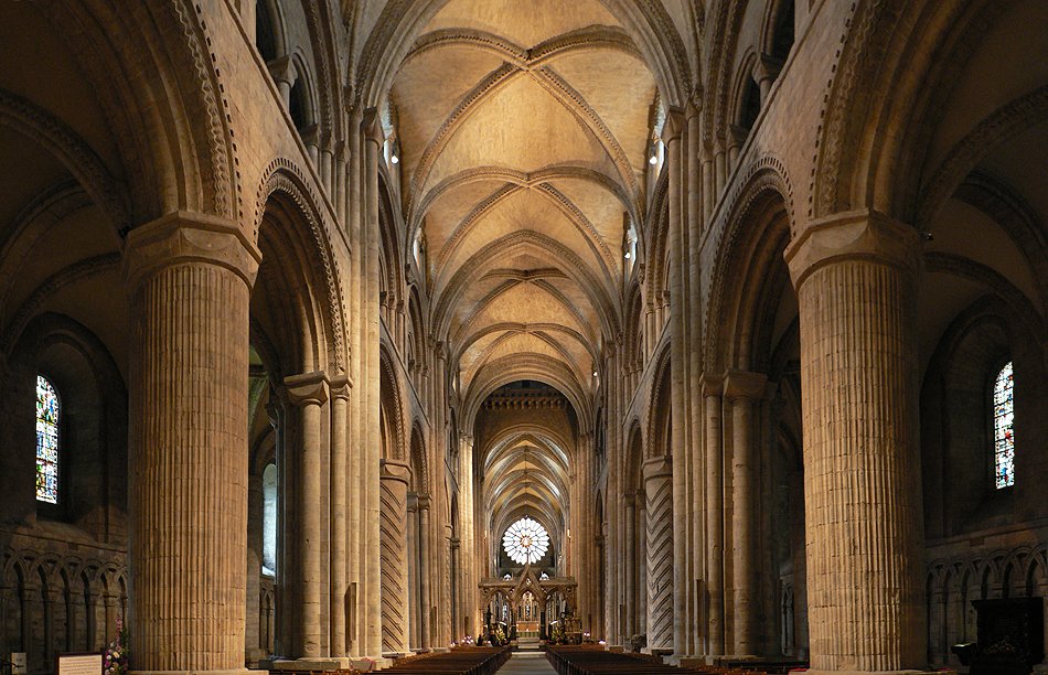 Romanesque vs Gothic: the massive round arches and thick zigzag-carved pillars of the Norman nave of Durham Cathedral