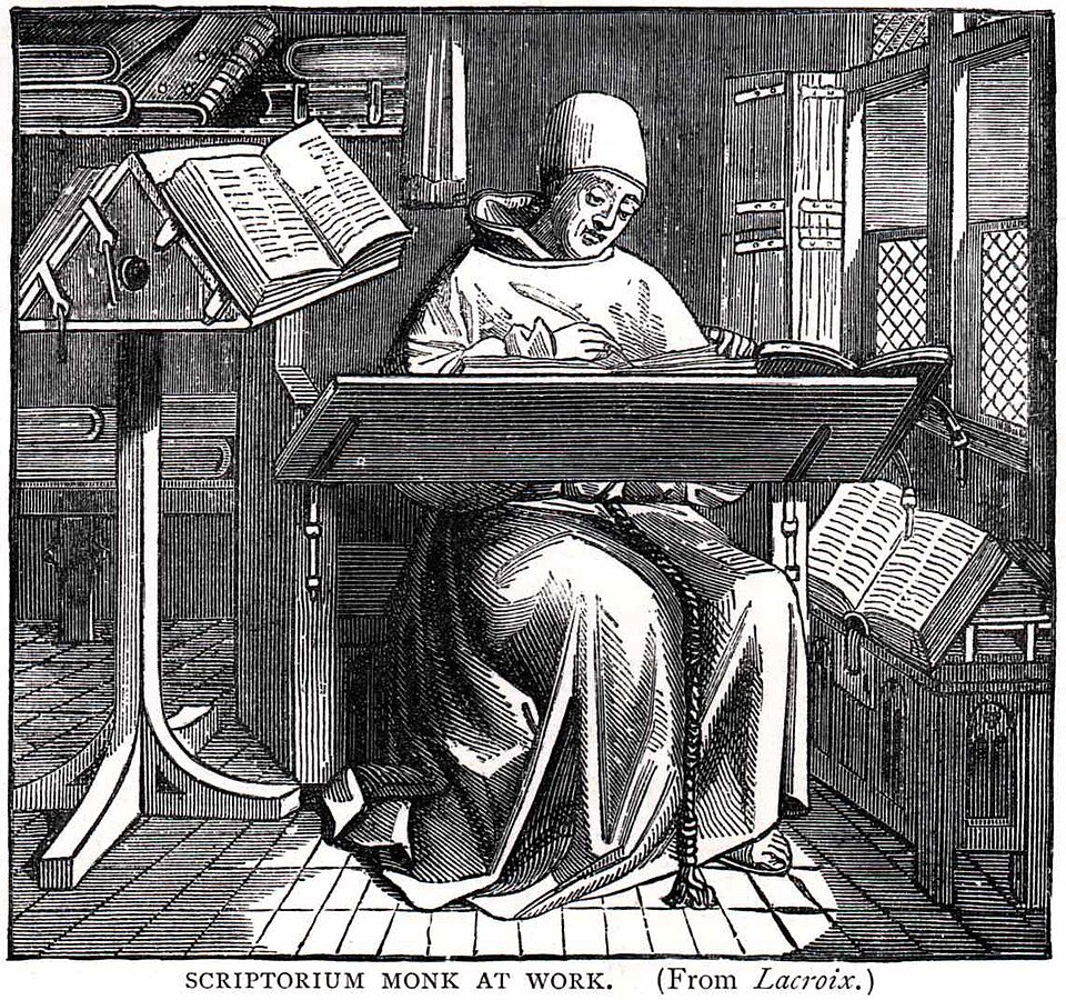 A medieval scribe copying a manuscript at his desk