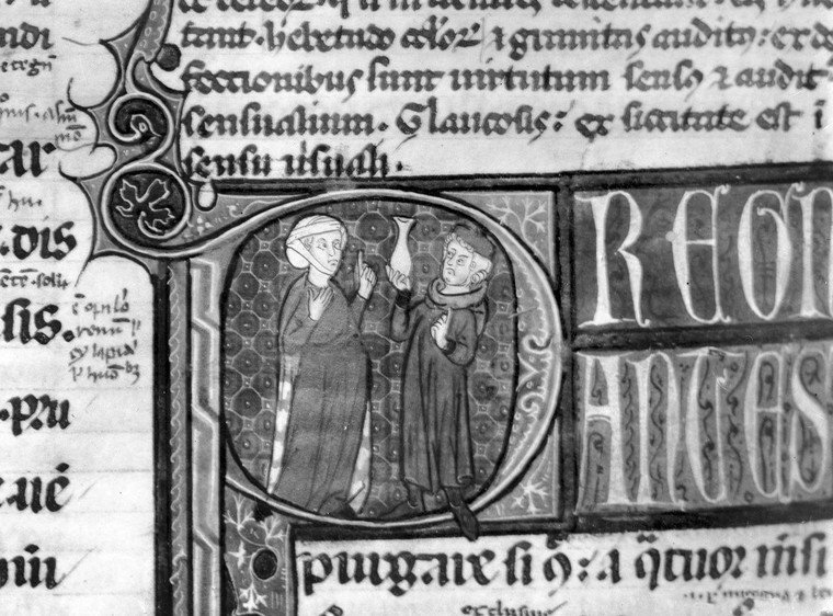 A physician, possibly a monk, holding up a flask that may contain urine beside a female patient, in a 14th-century manuscript